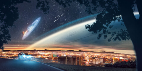 Surreal view of a big city. It is night and one can see stars and other unknown planets in the sky. © Paul