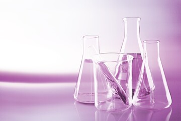 Set of glass laboratory equipment with fluid on desk