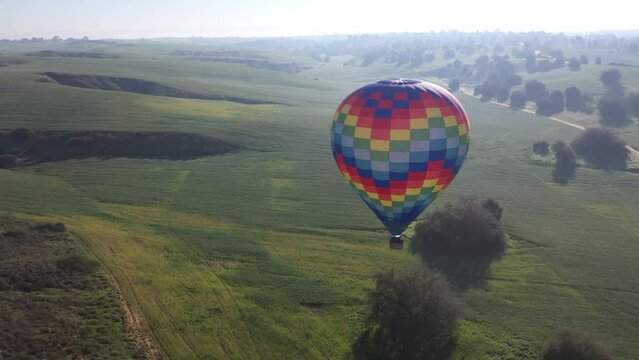 Hot air balloon above Ruhama green badlands