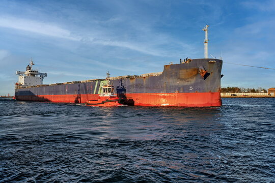 Port of Gdansk, Baltic Sea, A large bulk carrier with a displacement of 81,703 t DWT, built in 2019, enters the port with the assistance of tugboats, the ship is 228.99 meters long, 32 meters wide, an