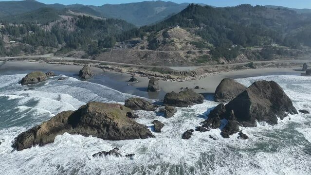 Afternoon sunlight shines on the rugged southern coast of Oregon and part of the Samuel H. Boardman State Scenic Corridor. This beautiful coastline is thickly forested and full of amazing viewpoints.