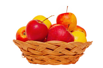 Red and yellow fresh tasty apples in a wicker plate. Useful product, apples.