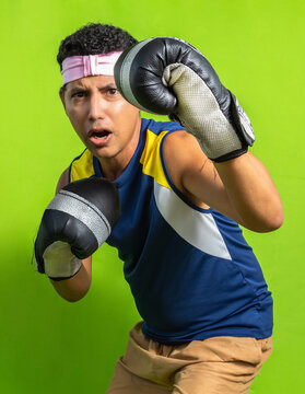 Man with boxing gloves and pink bandana screaming with an angry face