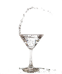 Cocktail Glass with splashing water alcohol, Crystal Cocktail drink splatter splash in air and bubble from glass. Liquor Part freeze shot high speed over black background isolated