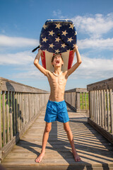 Youth Child Preteen Boy Standing on Beach Holding A Boogie Board Over His Head