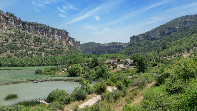 The lagoon of Uña and its mountains is located in the town of Uña, in the province of Cuenca (Castilla La Mancha, Spain). In the photo we can see mountains and also many green trees. Spain