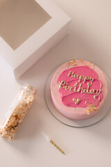 Cake packaging. The girl is tying the bank on the packing box.