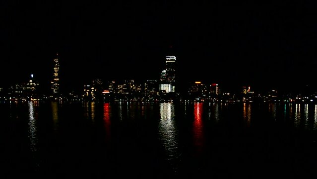 Boston night water cityscape with skyscrapers reflected in water of Charles river, night water reflection, America travel diversity.