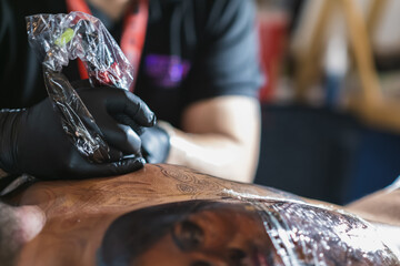 tattoo artist retouching tattoo, incredible tattoo details