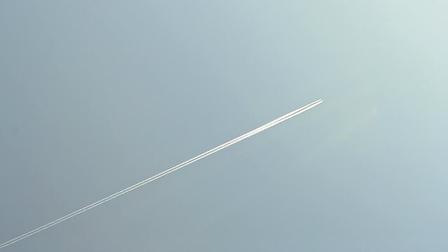 airplane white path on blue sky, abstract environment pollution, airliner flight diversity
