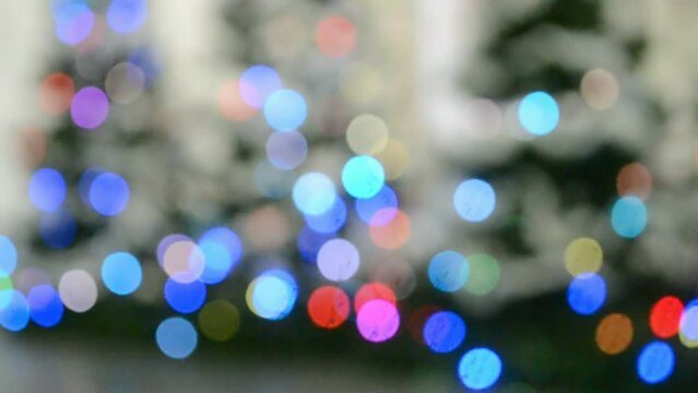 blurred holiday christmas tree under carnival illumination, rainbow led lamp light, blinking technology diversity