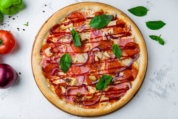 Pizza with meat and barbecue sauce and basil top view