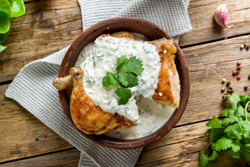 chicken chkmeruli in Georgian on old wooden table top view