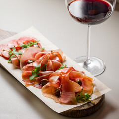 Italian Meat plate, parma ham, jamon, hamon, bresaola, chorizo with glass of red wine