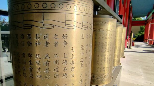 Spinning Tibetan prayer wheels in a Buddhist temple