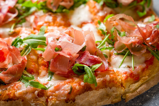 Pinsa with parma ham and aragula, rome pizza. macro close up