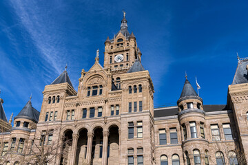 Fototapeta na wymiar Salt Lake City and County Building - A low-angle and wide-angle view of the historic Salt Lake City and County Building, against blue sky, on a sunny Winter evening. Downtown of Salt Lake City, Utah.