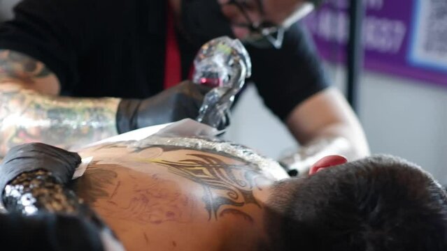 Transforming a Back: A Tattoo Artist's Creative Process on Display