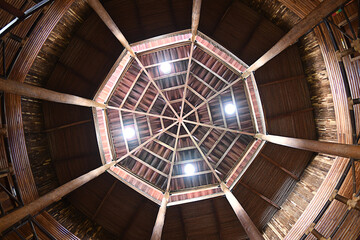 Octogonal ceiling made of wood, with spotlights, viewed from below