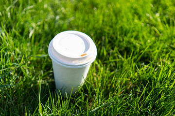 coffee cup in grass in spring