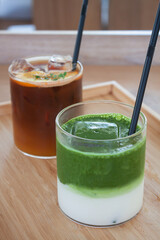 Iced americano with orange and iced matcha green tea in coffee shop