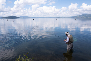Trout fishing, preparing the line, Lake Rotorua