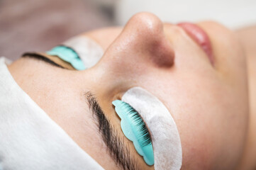Portrait of a woman in a beauty salon on the procedure of eyelash lamination. 