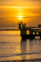 Obraz premium Sunset over diving tower