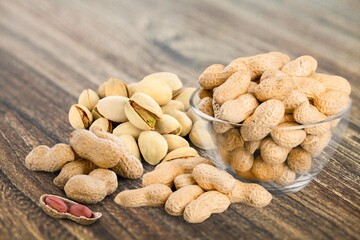 Mix of dry tasty nuts on a wooden desk