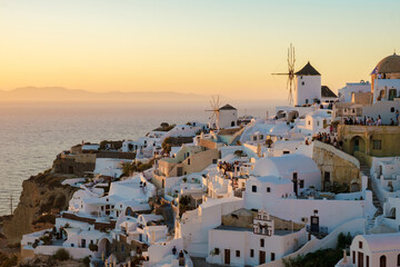 sunset by the ocean of Oia Santorini Greece, a traditional Greek village in Santorini with...