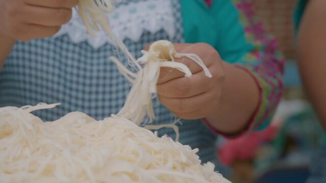 unbreak the quesillo traditional cheese from Oaxaca, Mexico.