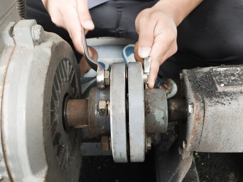 The technician repair Coupling Water pump connection driven motor.