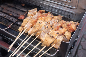 selective focus on tofu filled with meatballs, which are grilled over charcoal
