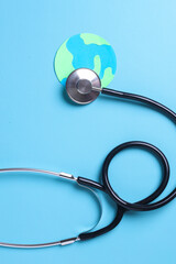 Globe with stethoscope isolated on blue background. Save the world, Global healthcare and Green Earth day concept