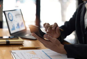 Female employee working on a laptop computer in a modern office. Make an account analysis report....