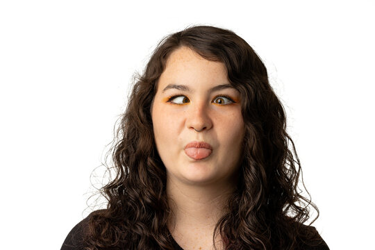 Young woman making a goofy face with crossed eyes and tongue