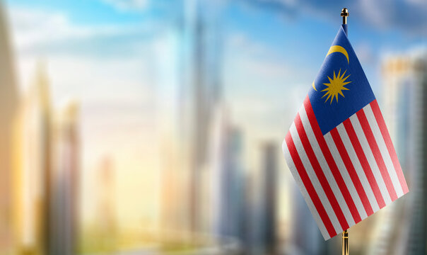 Small flags of the Malaysia on an abstract blurry background