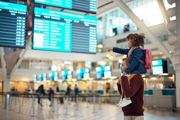 Airport, travel and father with his child on his shoulders reading the schedule or time board....
