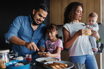 Hispanic family father and child daughter preparing breakfast at kitchen in Mexico Latin America
