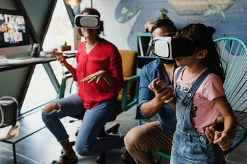 hispanic father playing virtual reality game with his family and daughter at home in Mexico Latin America