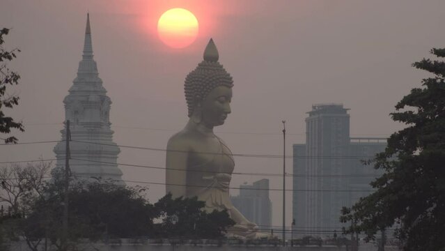 Giant Buddha, Evening sunset timelapse behind the Giant Buddha Statue at Wat Paknam Phasi Charoen in Bangkok, Thailand.