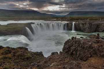 Beautiful Icelandic waterfall at sunset with huge quantity of flowing waters Iceland