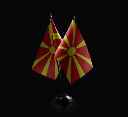 Small national flags of the Macedonia on a black background