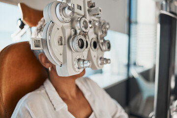 Healthcare test, eye exam and woman in optometry clinic for vision, eyesight and optical assessment. Glasses, optometrist consultation and patient with medical equipment, phoropter and lens for eyes