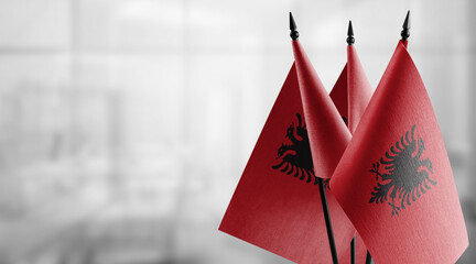 A small Albania flag on an abstract blurry background