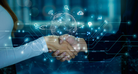 Business and Technology concept. Businessman and Businesswoman shake hands with digital and...