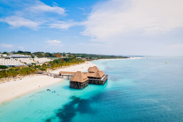 Fototapeta na wymiar This drone shot of Nungwi Beach in Zanzibar captures the incredible beauty of the shoreline, with crystal-clear waters and golden sand providing a picture-perfect view.