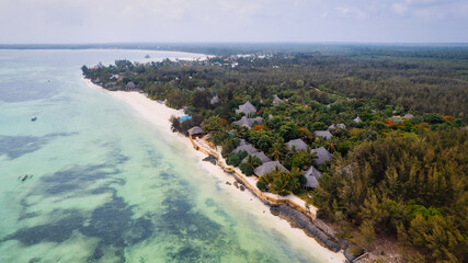 Fototapeta na wymiar Aerial drone photography captures the breathtaking beauty of Zanzibar's crystal clear waters and white sandy beaches in Nungwi.