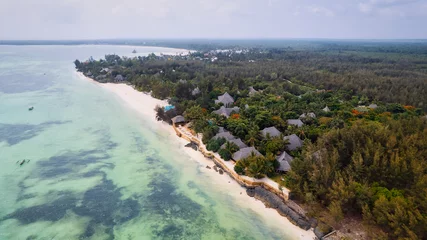 Photo sur Plexiglas Plage de Nungwi, Tanzanie Aerial drone photography captures the breathtaking beauty of Zanzibar's crystal clear waters and white sandy beaches in Nungwi.