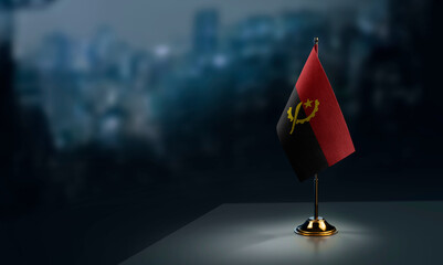 A small Angola flag on an abstract blurry background